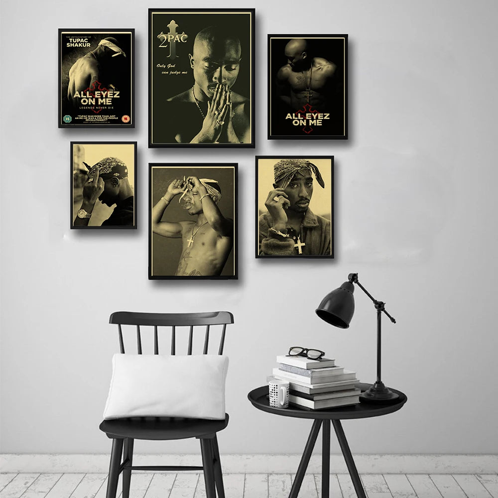 A gallery wall featuring several posters of Tupac Shakur in black and white tones.