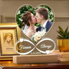 A custom acrylic heart photo frame featuring a couple kissing, set on a wooden surface.
