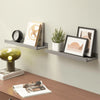 A rustic floating wood shelf set featuring framed art and a clock on a light gray wall.