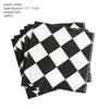 A stack of black and white checkered paper towels for a birthday racing car party decoration set