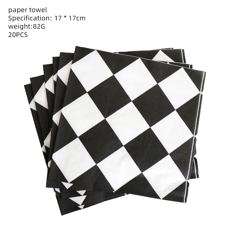 A stack of black and white checkered paper towels for a birthday racing car party decoration set
