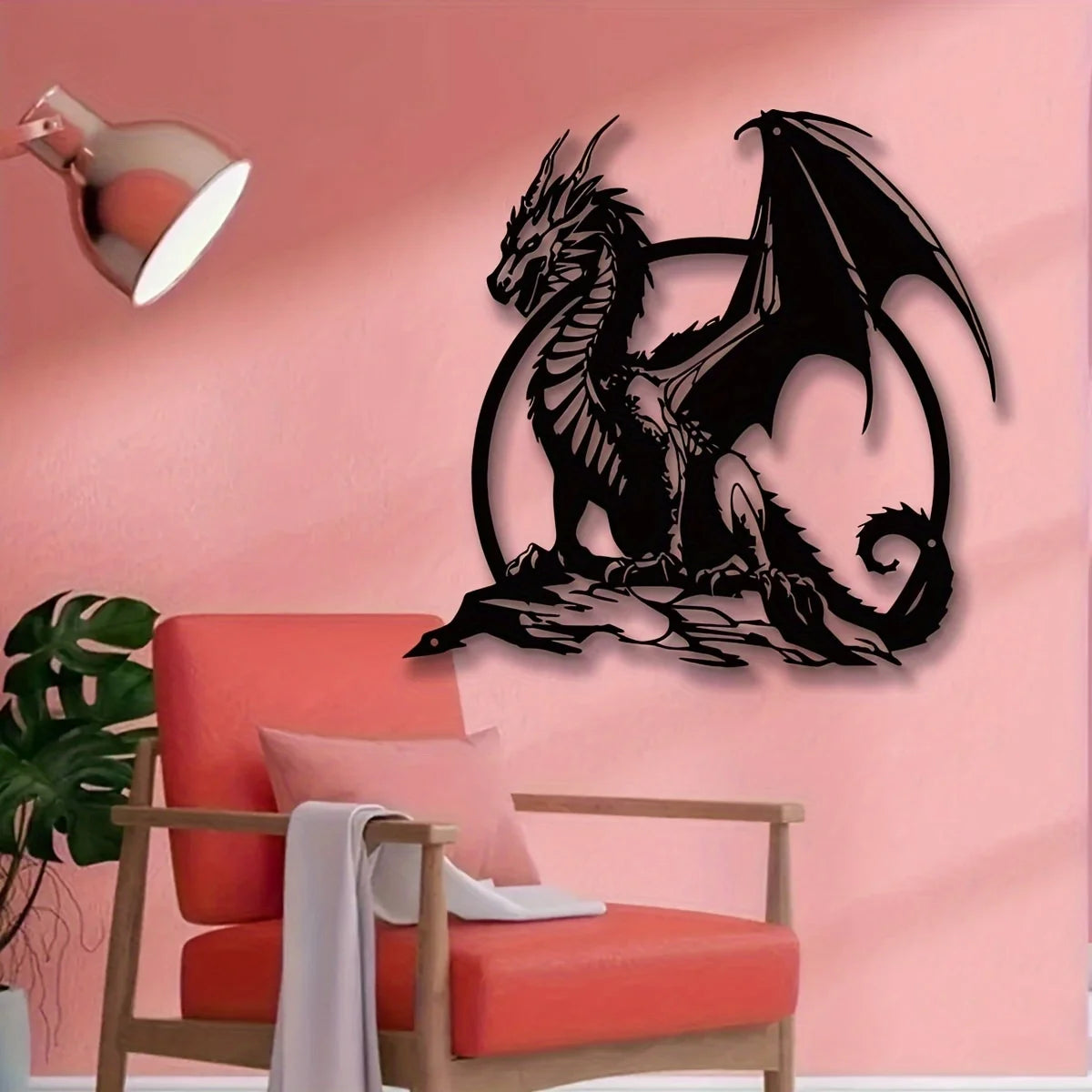 A black metal dragon wall sculpture is mounted on a pink wall above an orange chair.