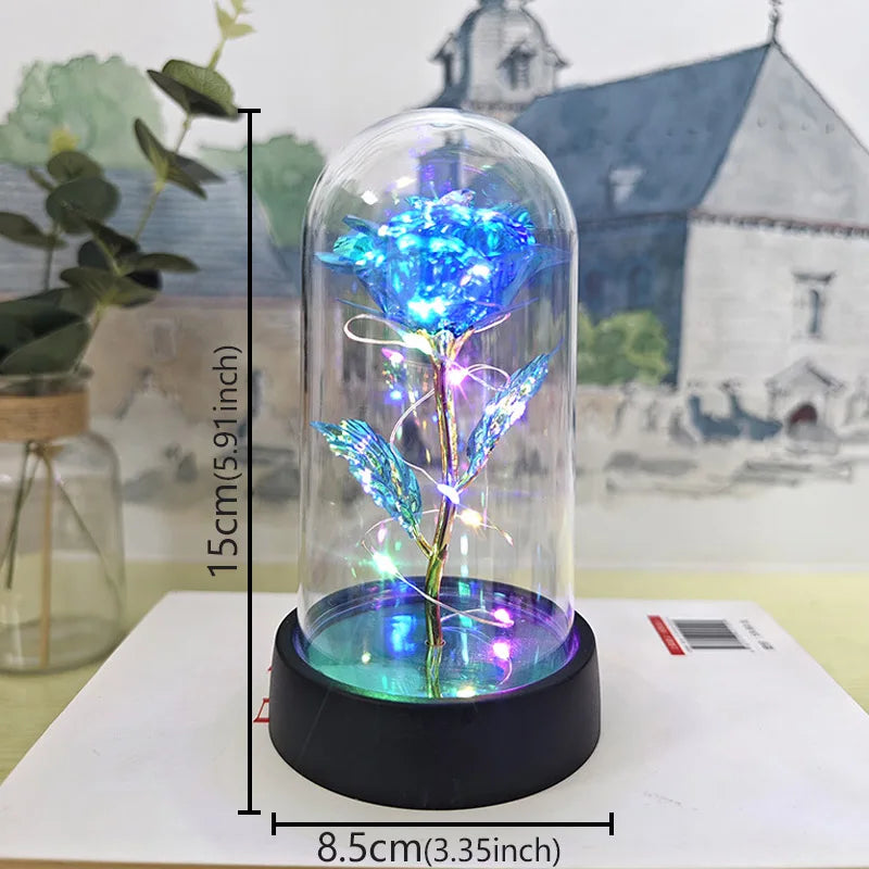 A glass dome containing an eternal rose with blue LED light, displayed on a black base.