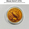 A round gold-toned challenge coin featuring a crow and skull design.