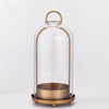 Antique brass metal candle holders with glass domes on a round base