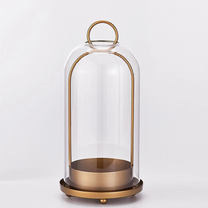 Antique brass metal candle holders with glass domes on a round base
