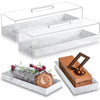 Clear acrylic cake stand with a lid displaying rectangular marbleized desserts on a white marble tray