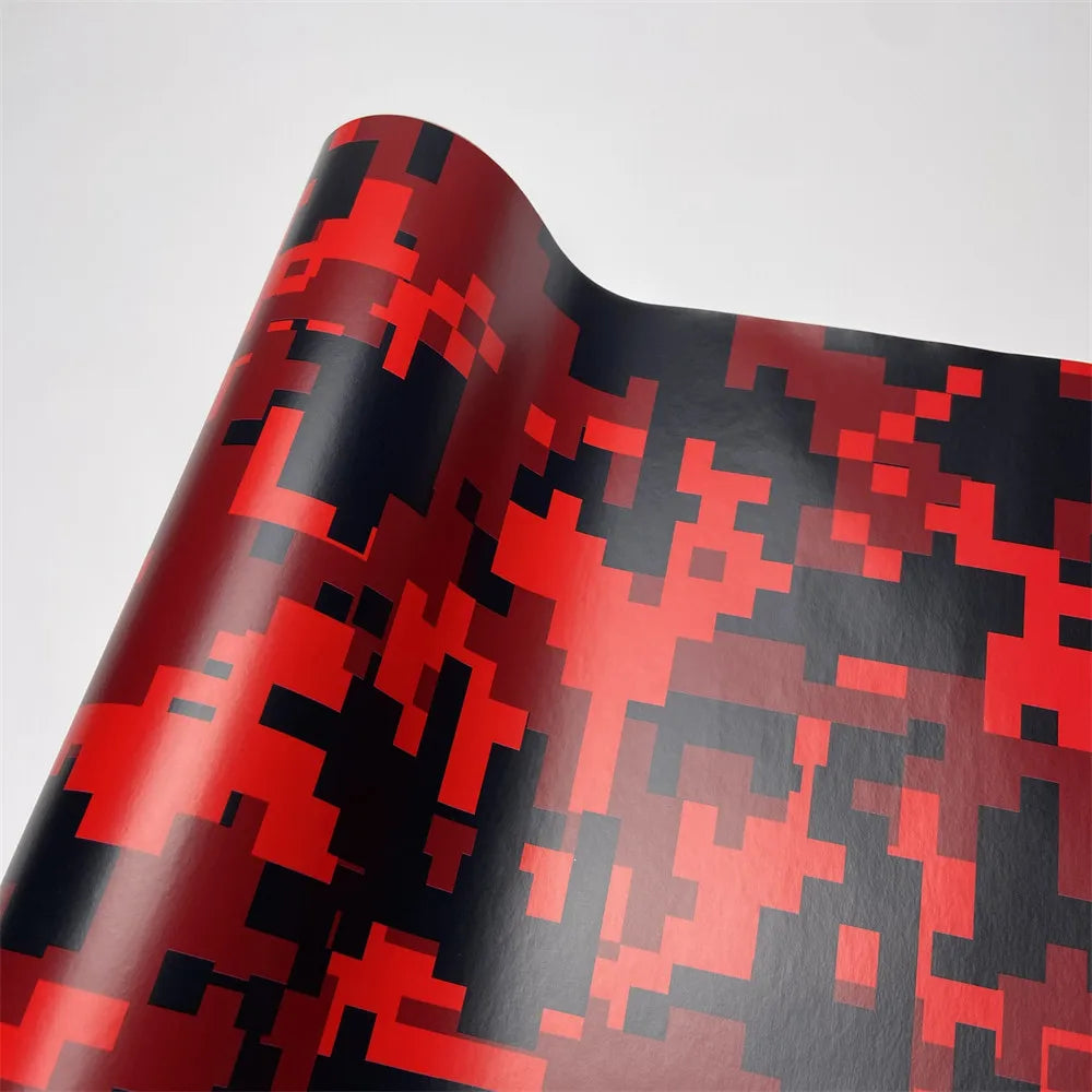 A close-up of a color-changing digital camouflage vinyl wrap film showing red and black patterns.