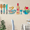 A set of rustic wood floral kitchen decor including a fork, spoon, knife, teacup, and wine glass