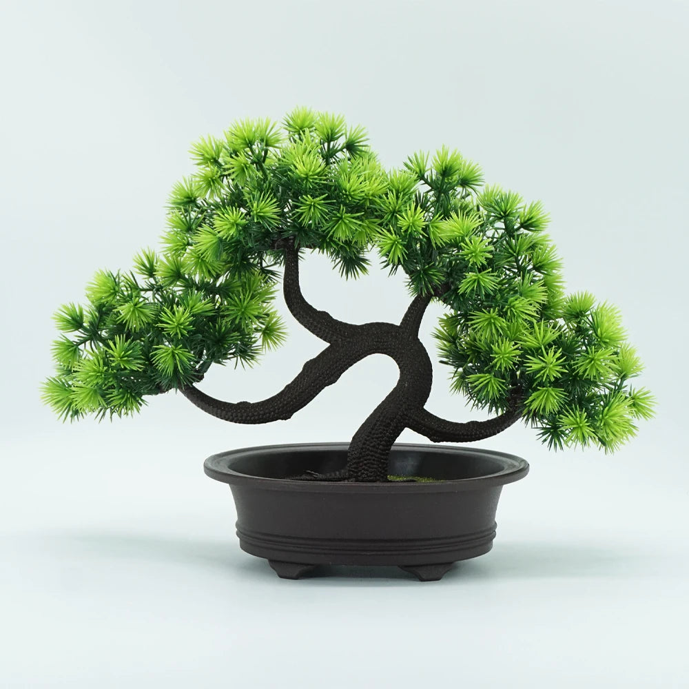 An artificial bonsai pine tree with dark bark and bright green needles planted in a black pot.