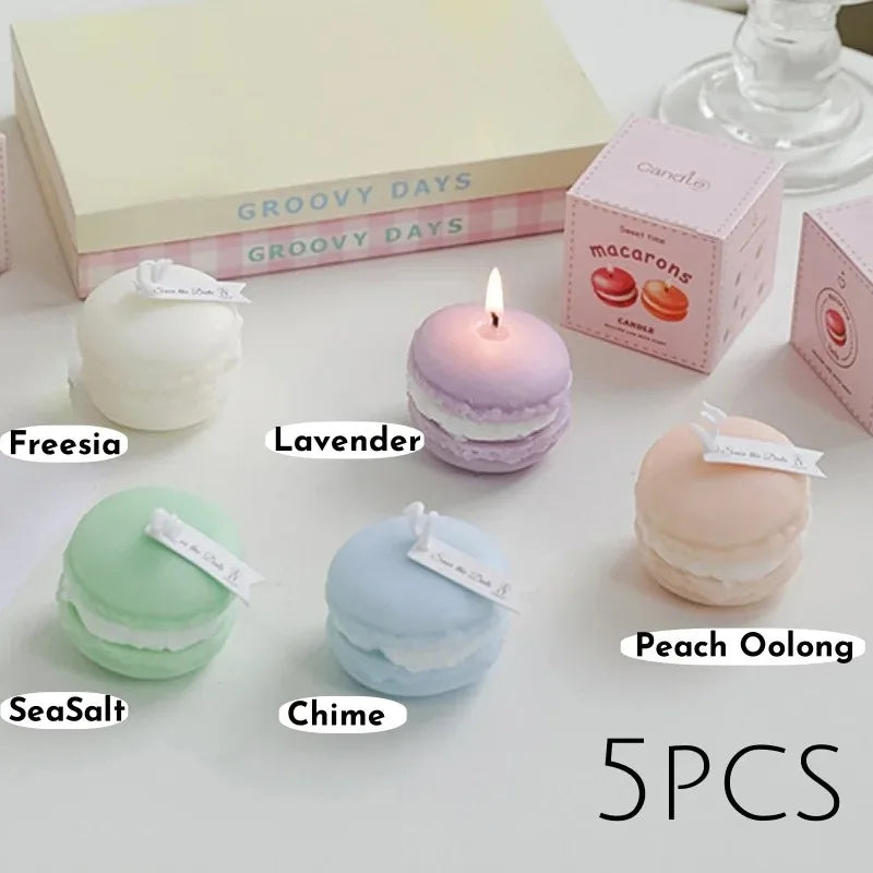 Five macaron-shaped scented soy wax candles in pastel colors including lavender, pink, green, blue, and peach.