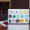 A white laptop features a set of colorful inspirational quote stickers on the lid.