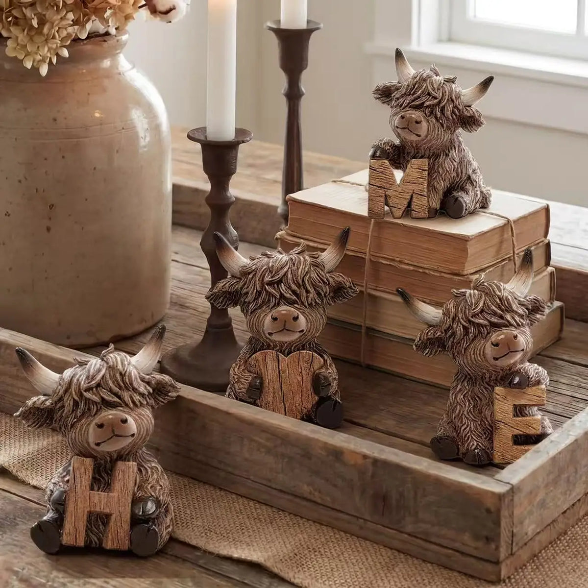 A rustic wooden decorative set featuring a Highland cow figurine and letters H, E, L, L, O, in a wooden box.