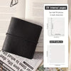 A black faux leather photo album with a flap closure and internal pages shown next to a handwritten recipe card.
