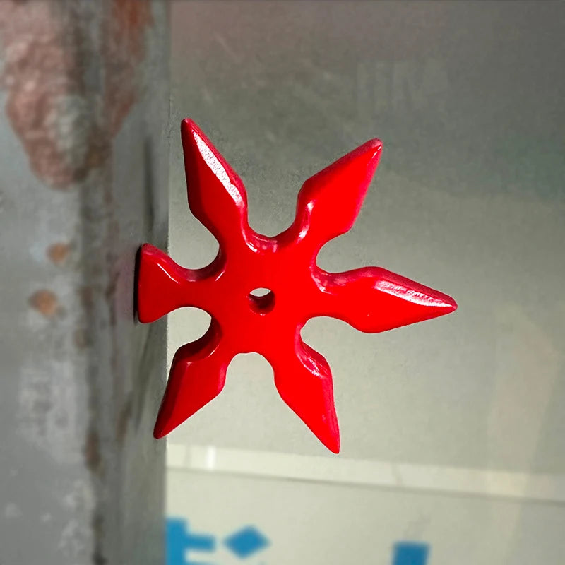 A bright red, star-shaped 3D axe fridge magnet is displayed against a light gray background.