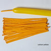 A collection of lemon yellow latex strip balloons and a yellow balloon stick.