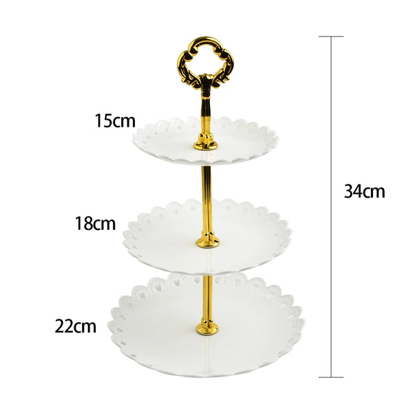 A three-tier gold-colored decorative stand for fruit and dessert display.