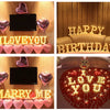 A display of warm white LED alphabet letter lights spelling out I LOVE YOU and HAPPY BIRTHDAY with heart shapes.