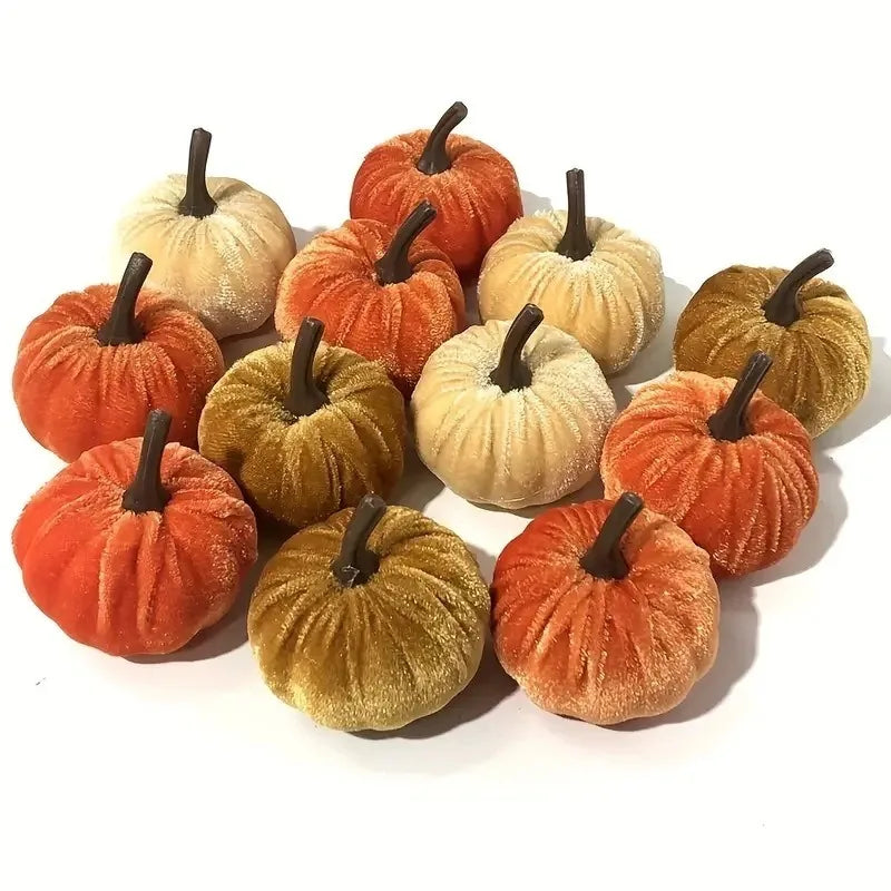 A set of ten velvet pumpkin decorations in various shades of orange, gold, and tan for fall and holiday styling.