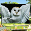 A flag tapestry featuring a close-up image of an owl with large white wings and dark eyes.