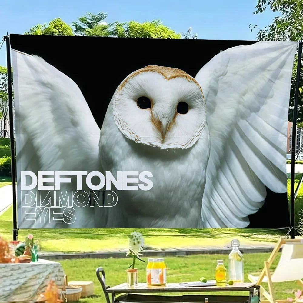 A flag tapestry featuring a close-up image of an owl with large white wings and dark eyes.