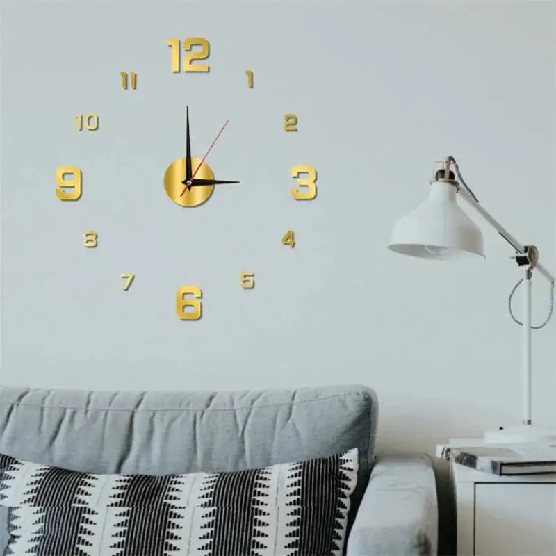 A round gold-colored wall clock with Roman numerals and hands is mounted on a light gray wall above a sofa.