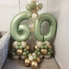 A large vintage number balloon set shaped like 60 in various shades of green and gold balloons for birthday decor