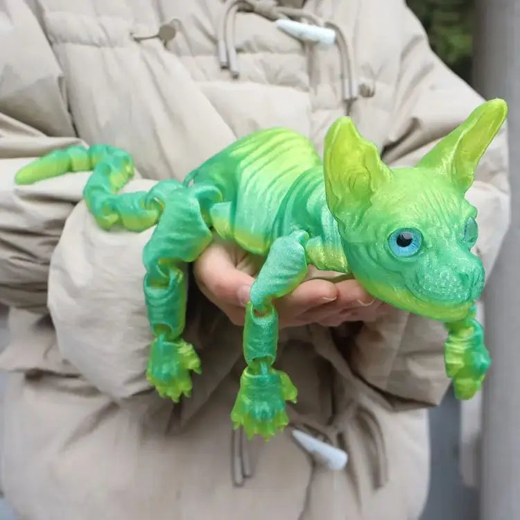 A hand holds a realistic green Sphynx cat fidget toy against a light-colored jacket.