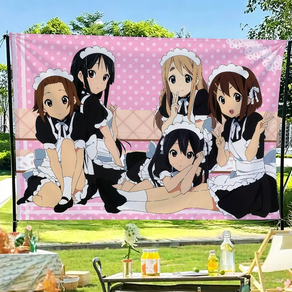 A pink and white anime flag tapestry featuring characters from K-On! in a cheerful style.