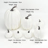 A set of seven white artificial pumpkins of various sizes and heights for fall and Halloween decoration.