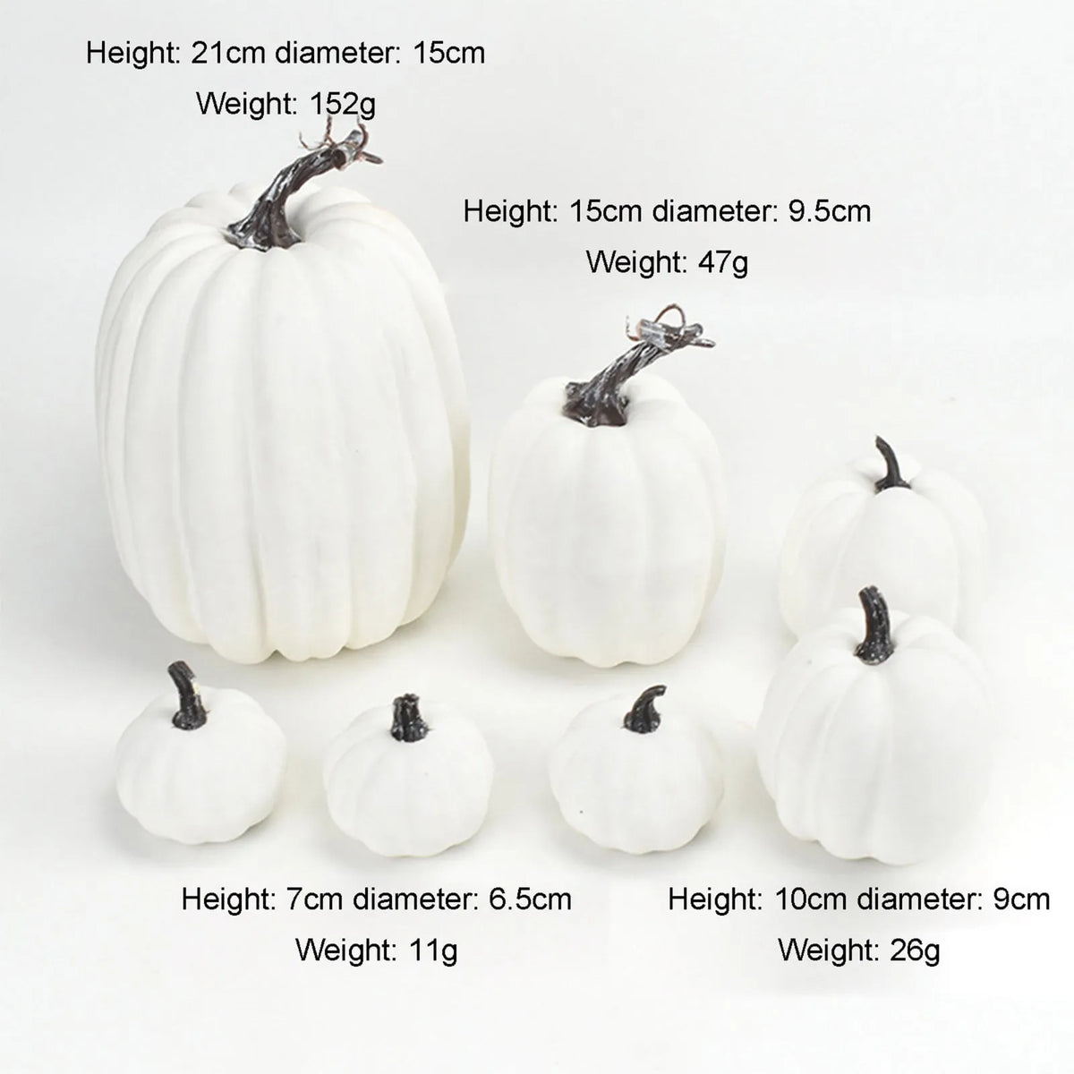 A set of seven white artificial pumpkins of various sizes and heights for fall and Halloween decoration.