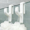 White 3D shower door towel hooks hanging from a glass panel