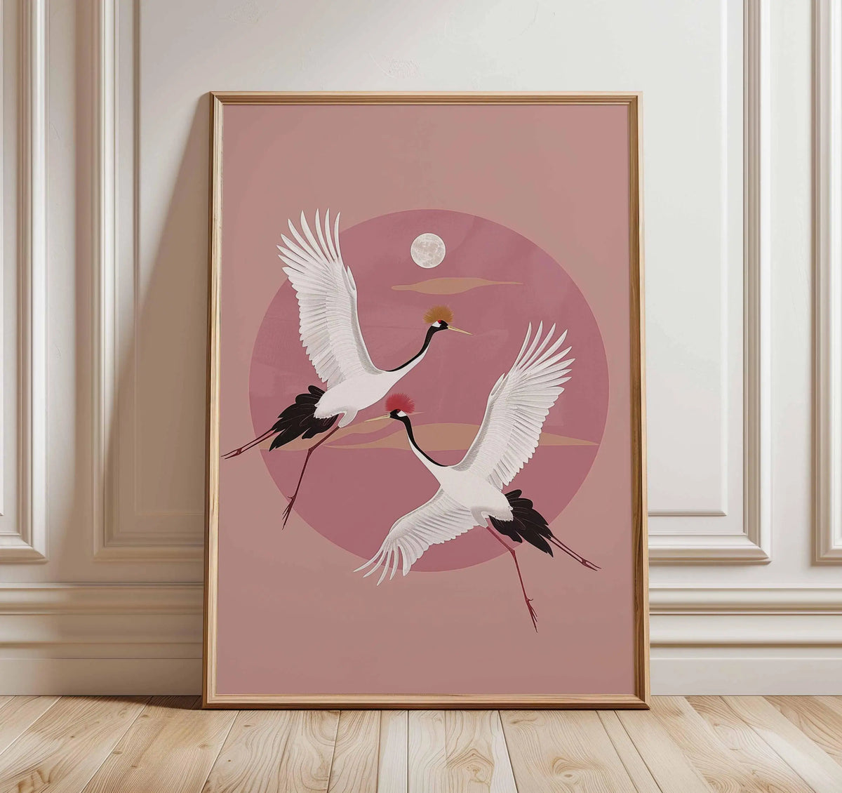 Pink canvas wall art featuring a white crane in flight against a pink circle and a small moon.