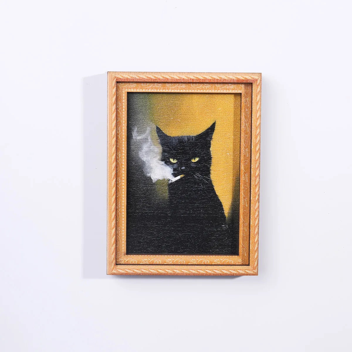 A framed artwork depicting a black cat smoking, set in a wooden frame.