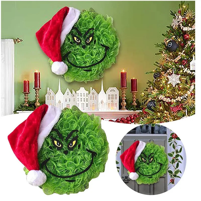 Green monster Christmas wall decor featuring a festive face and a Santa hat