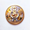 A round gold coin featuring an eye symbol, crescent moons, and a tree, symbolizing abundance and wealth.