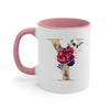 A pink ceramic coffee mug featuring a gold letter Y decorated with floral watercolor accents.