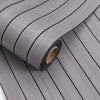 Roll of self-adhesive 3D wood grain wall panels in gray with vertical lines.