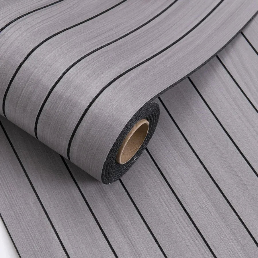 Roll of self-adhesive 3D wood grain wall panels in gray with vertical lines.