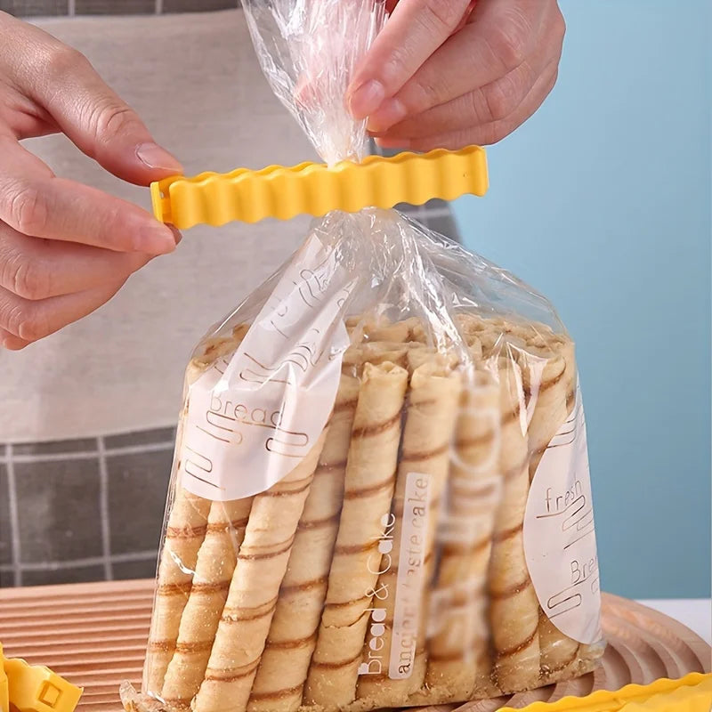 Hands are sealing a bag of french fry shaped decorative clips for food packaging.