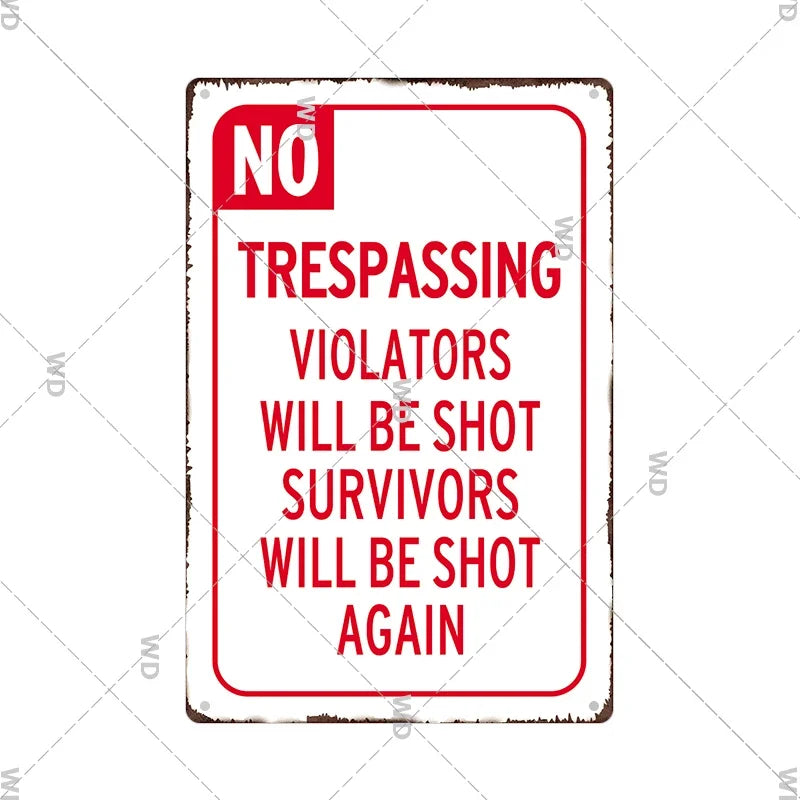 A vintage red and white metal warning sign with the text NO TRESPASSING VIOLATORS WILL BE SHOT SURVIVORS WILL BE SHOT AGAIN