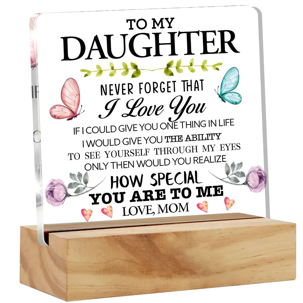 A personalized acrylic desk sign with a floral design and the message I love you to my daughter