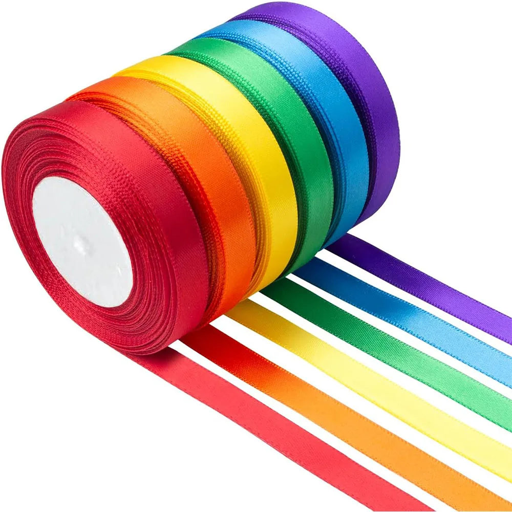 A roll of satin silk ribbon in a rainbow spectrum, showing various colors like red, orange, yellow, green, blue, and purple.