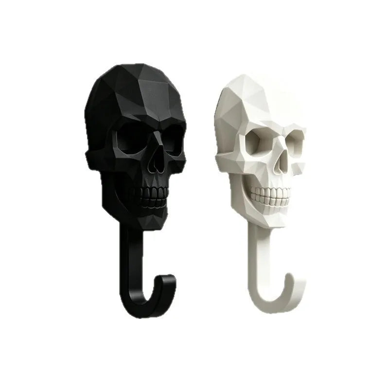 A pair of black and white 3D skull wall hooks for decor