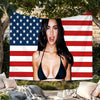 A woman wearing a black top is positioned in front of a large American flag tapestry featuring red, white, and blue stripes a