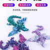 A collection of 3D printed articulated dragon fidget figurines in various iridescent colors like blue, purple, and pink.