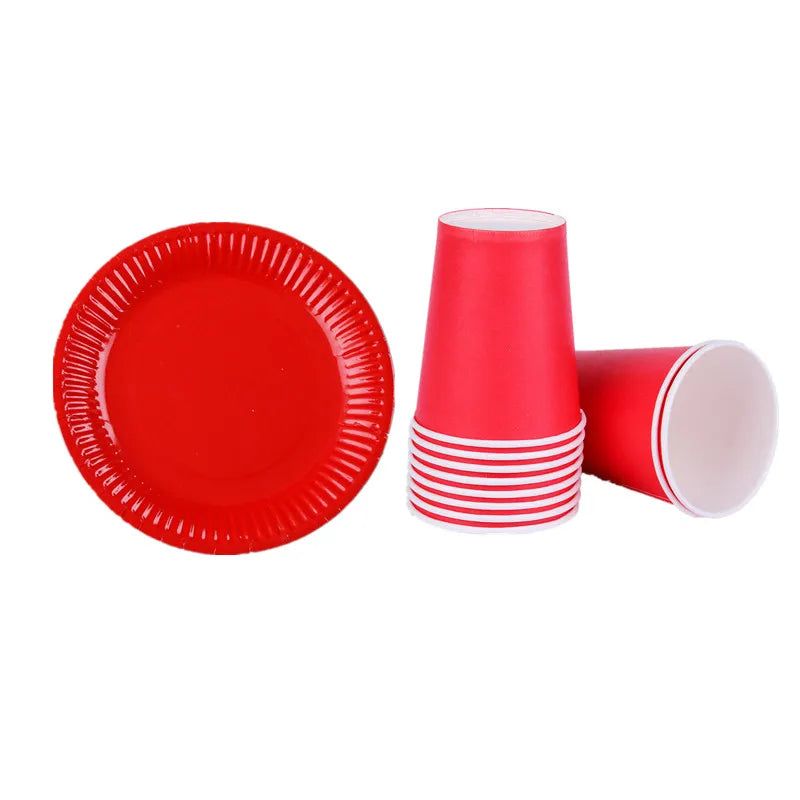 A set of red disposable tableware including a plate and a paper cup with white stripes.