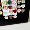 A collection of eight heart-shaped checkered fridge magnets in various colors and patterns.