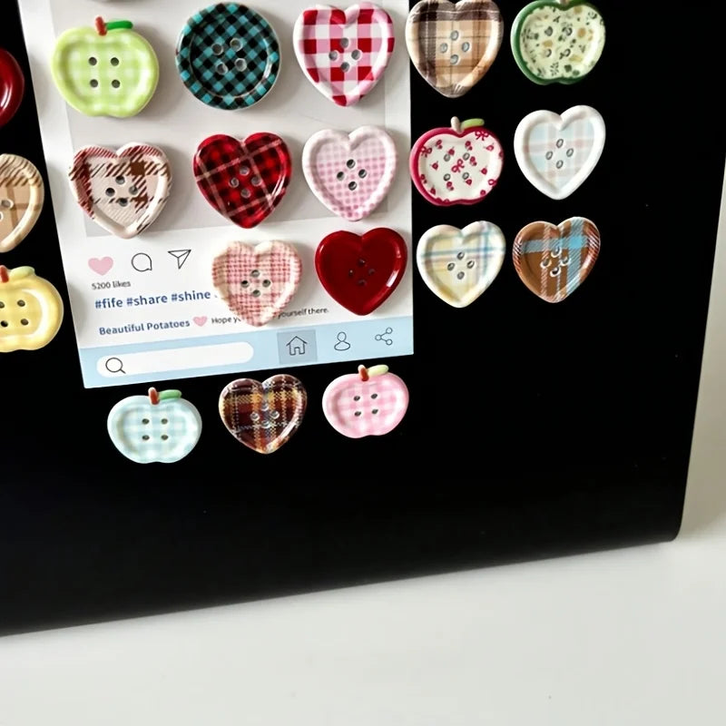 A collection of eight heart-shaped checkered fridge magnets in various colors and patterns.