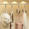 A display of various hats and bags hanging from metal rings for organization